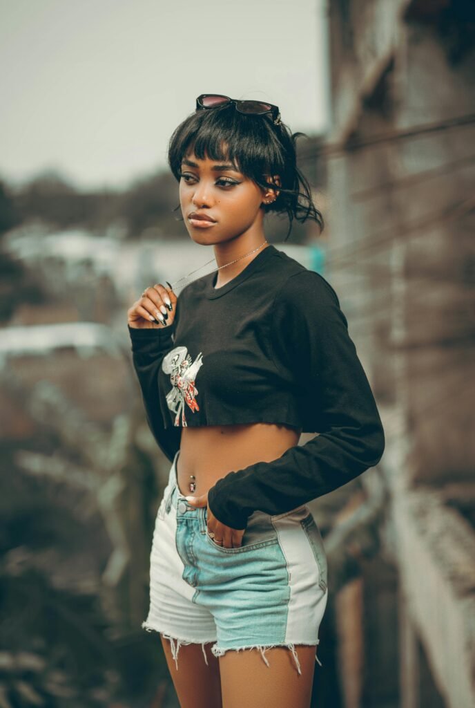 Young woman posing outdoors in trendy casual wear with a confident look.