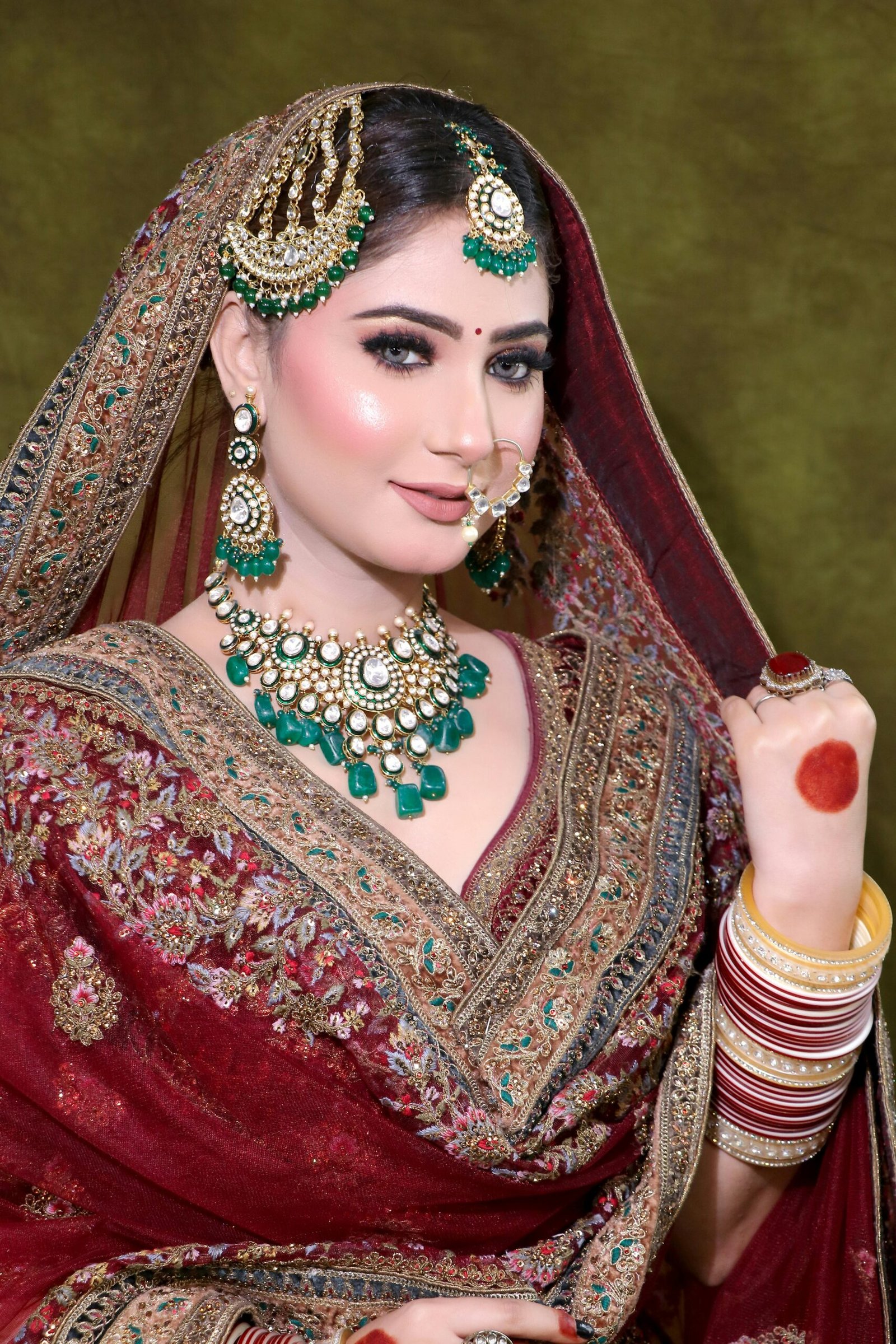 Stunning South Asian bride in traditional attire adorned with intricate jewelry.